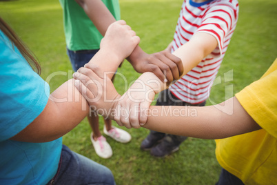 Diverse classmates holding arms