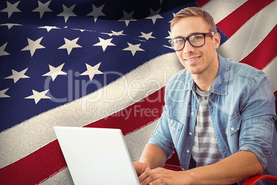 Composite image of hipster on laptop