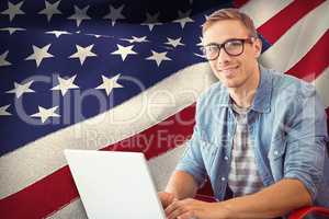 Composite image of hipster on laptop