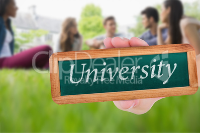 University against happy students sitting outside on campus