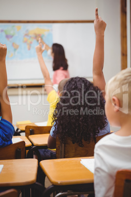 Students raising hands to answer a question