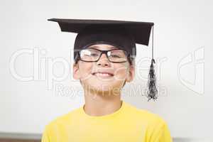Smiling pupil with mortar board and glasses