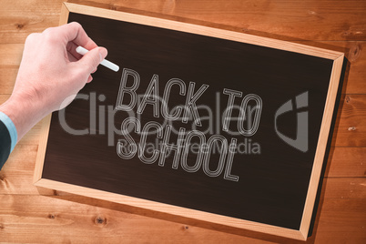 Composite image of hand writing with a white chalk