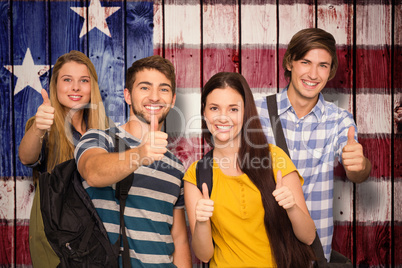 Composite image of happy students gesturing thumbs up at college