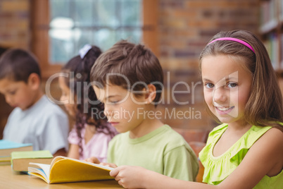 Pupils reading books in library