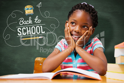 Composite image of pupil sitting at her desk