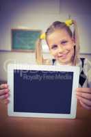 Smiling pupil showing tablet to camera