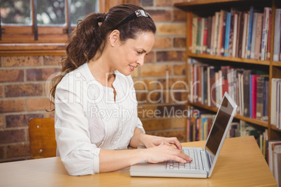 Teacher using laptop in her office