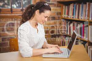 Teacher using laptop in her office