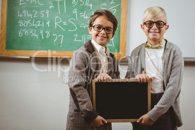 Pupils dressed up as teachers holding chalkboard