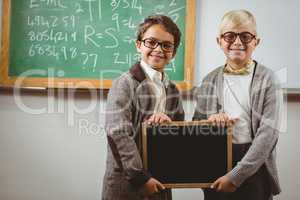 Pupils dressed up as teachers holding chalkboard