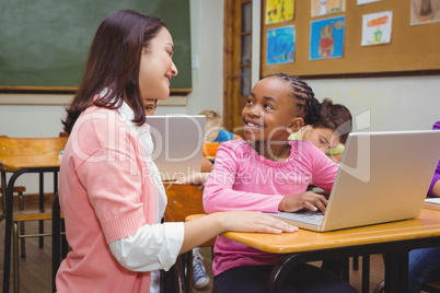 Happy teacher using laptop with student Happy teacher using laptop with student