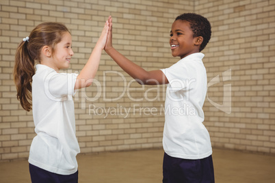 Happy pupils giving each other a high five