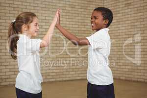 Happy pupils giving each other a high five
