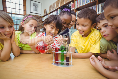 Pupils and teacher doing science in library