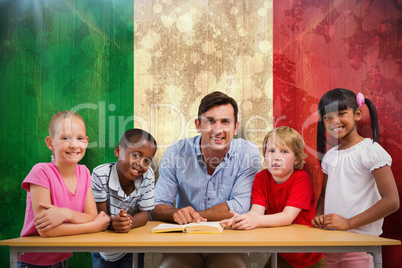 Composite image of teacher and pupils smiling at camera at library