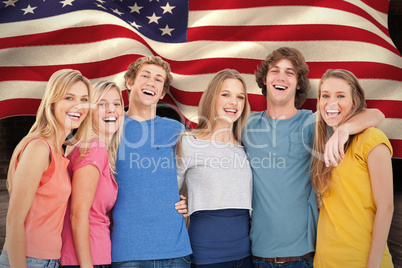 Composite image of a group of friends holding each other and smi