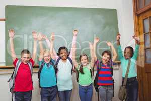 Students with arms raised together