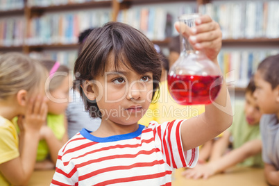 Pupil doing science in library