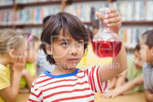 Pupil doing science in library