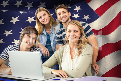 Composite image of students using laptop in classroom