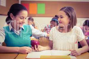 Pupil offering an apple to teacher