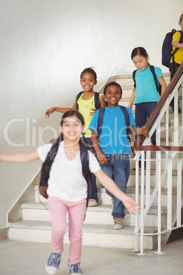 Happy pupils walking down the stairs