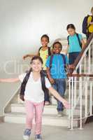 Happy pupils walking down the stairs