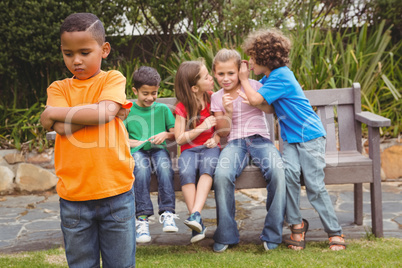 Upset child standing away from group