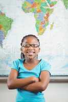 Cute pupil standing in front of world map