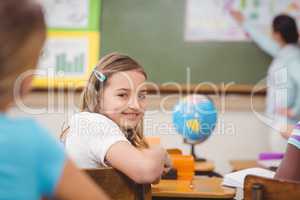 Pupil smiling at camera during class