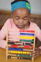 Focused pupil calculating with abacus in a classroom
