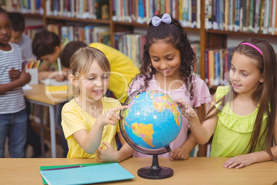 Pupils in library with globe