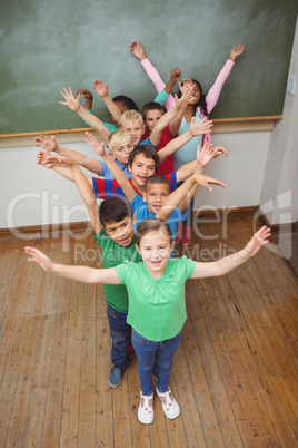 Students with arms raised together