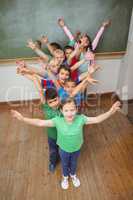 Students with arms raised together