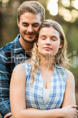 Happy smiling couple embracing with eyes closed