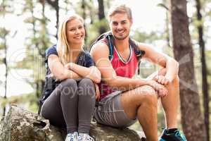 Young happy hiker couple looking at camera