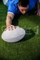 A rugby player scoring a try