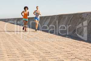 Two young women jogging together