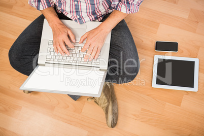 Casual man sitting and working with laptop