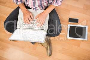 Casual man sitting and working with laptop