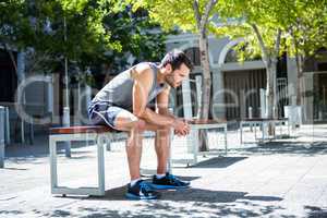Exhausted athlete resting on a bench