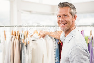 Smiling man browsing clothes