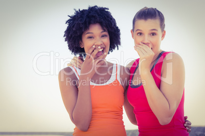 Two young women laughing to camera