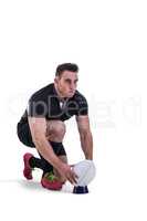 Rugby player getting ready to kick ball