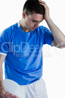 Disappointed rugby player holding his head