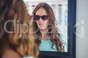 Pretty woman shopping for sunglasses