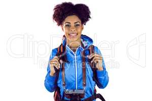Portrait of a young woman with camera and backpack