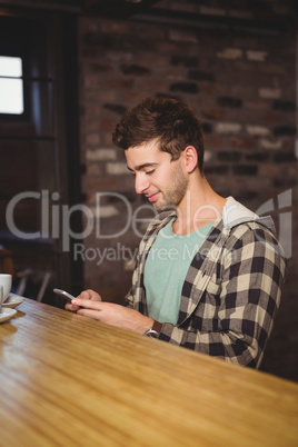 Smiling hipster sitting and texting