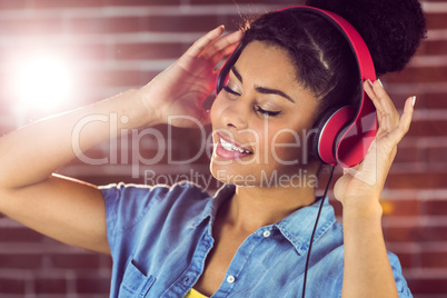 A smiling woman being transported by music